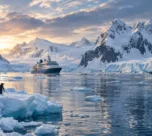 Expedition ship sailing through a pristine polar landscape surrounded by glaciers and wildlife